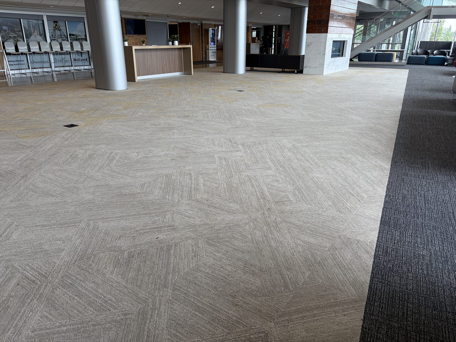 Freshly cleaned carpet across a modern commercial lobby